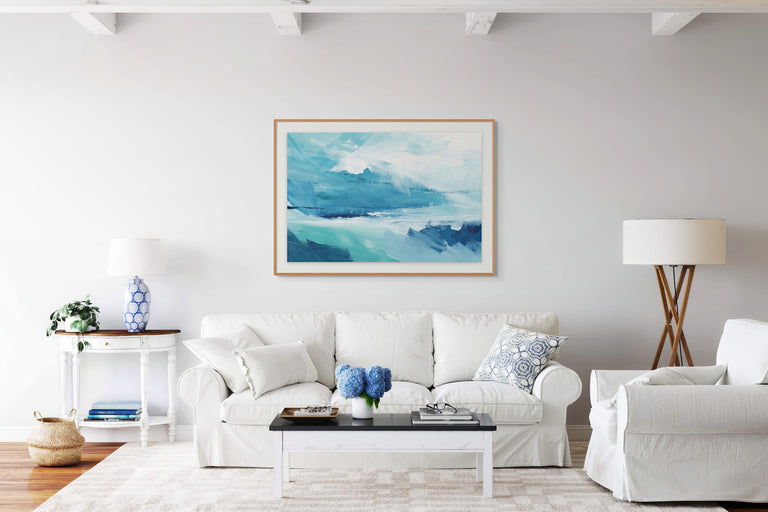 Modern living room with white furniture and a large abstract painting on the wall.